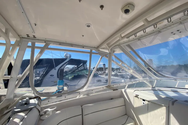 Slide: The Image of Interior view of a 2001 Intrepid 377 Walkaround boat with marina background. - 34