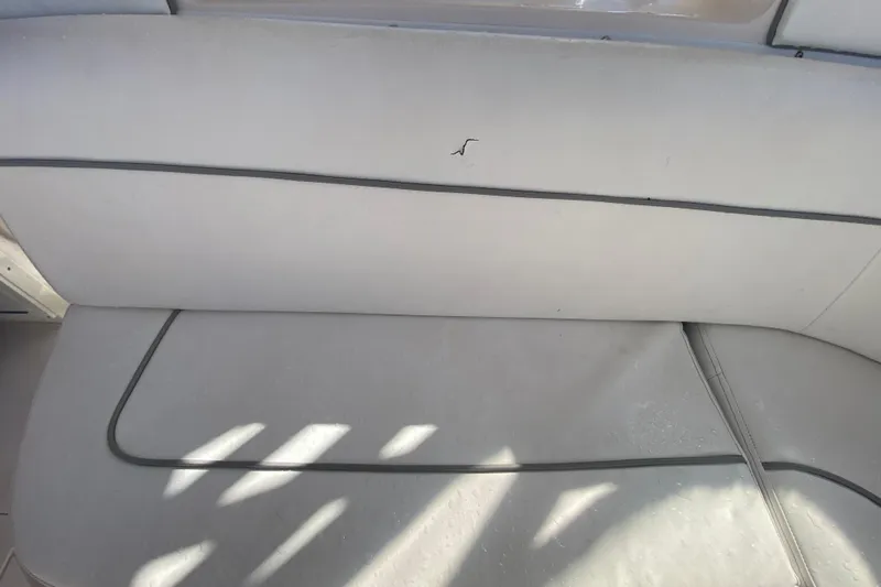 Slide: The Image of 2001 Intrepid 377 Walkaround boat seat with minor tear and sunlight shadows. - 37