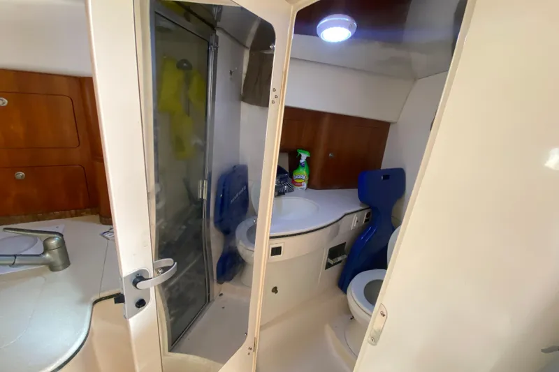 Slide: The Image of 2001 Intrepid 377 Walkaround boat bathroom with shower, sink, and toilet. - 42
