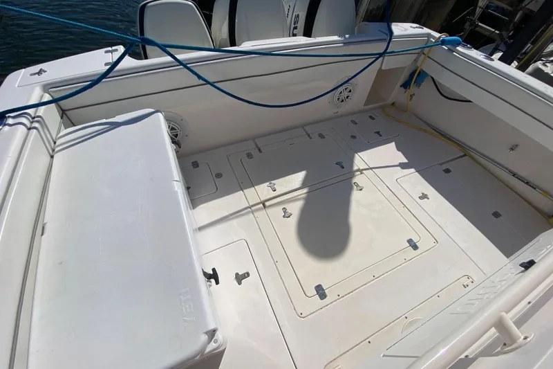 Slide: The Image of 2001 Intrepid 377 Walkaround boat deck with storage compartments and seating. - 43