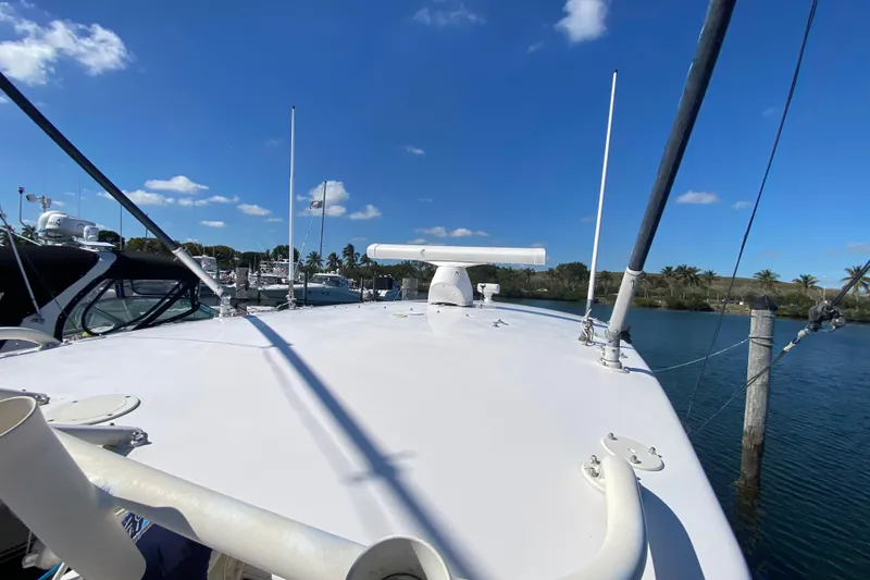 Slide: The Image of 2001 Intrepid 377 Walkaround boat docked under clear blue sky. - 48