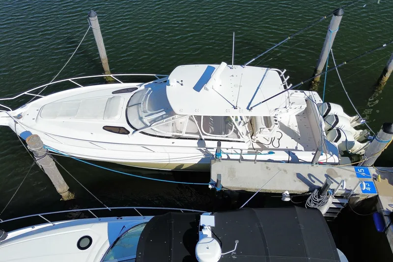 Slide: The Image of Aerial view of a 2001 Intrepid 377 Walkaround boat docked at a marina. - 51