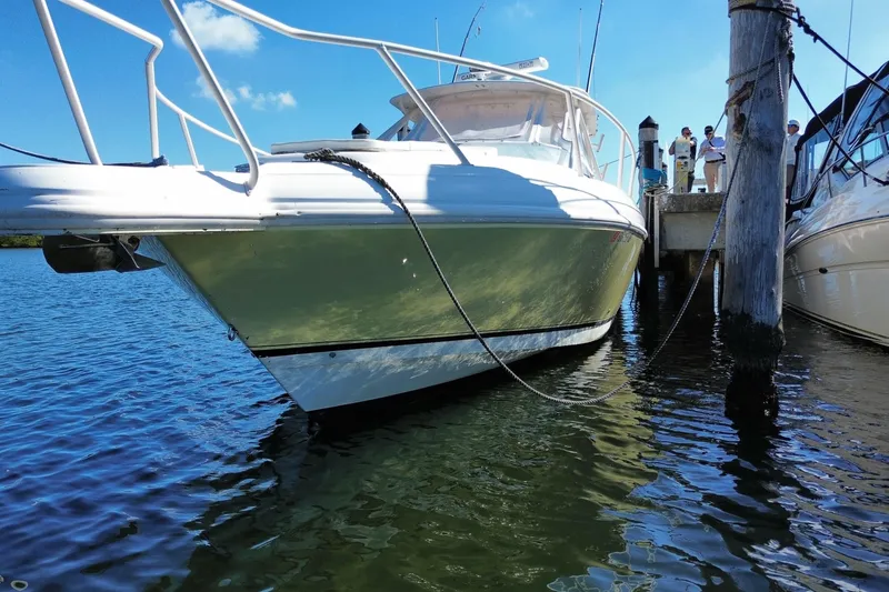 Slide: The Image of 2001 Intrepid 377 Walkaround boat docked in sunny marina. - 6