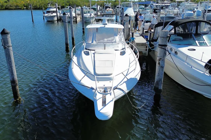Slide: The Image of 2001 Intrepid 377 Walkaround boat docked at marina, surrounded by other vessels. - 7