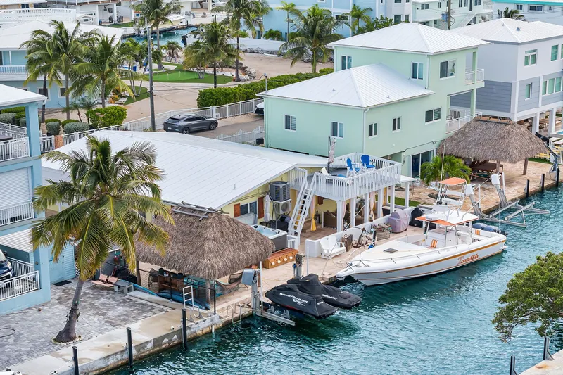 The Image of Intrepid 356 boat docked by waterfront homes, 2000 model. - 0