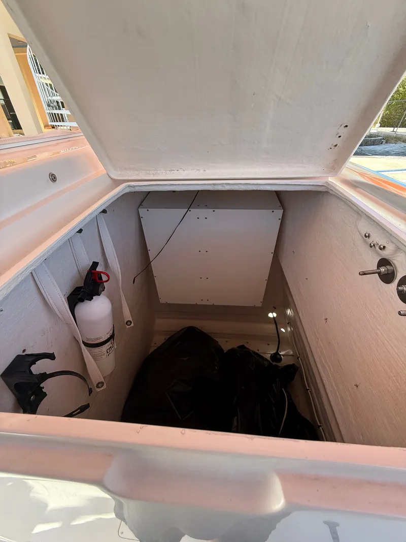 Slide: The Image of Open storage compartment of a 2000 Intrepid 356 boat. - 14