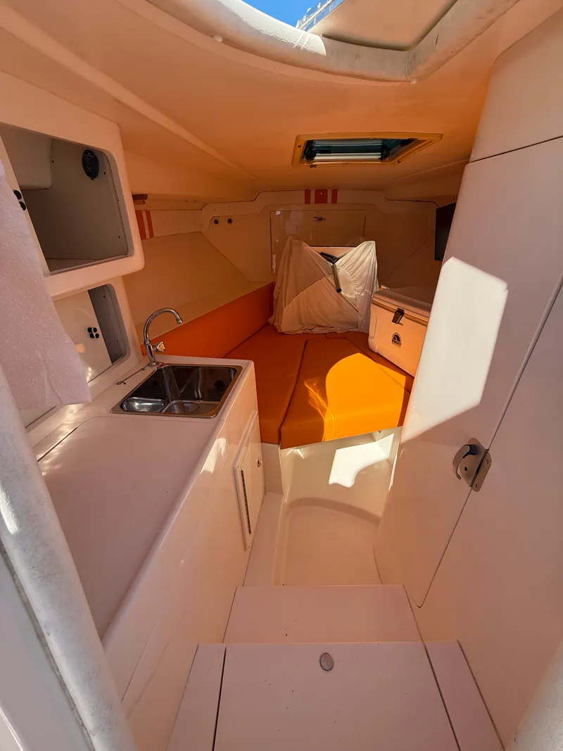 Slide: The Image of Interior of a 2000 Intrepid 356 yacht with kitchen and sleeping area. - 15
