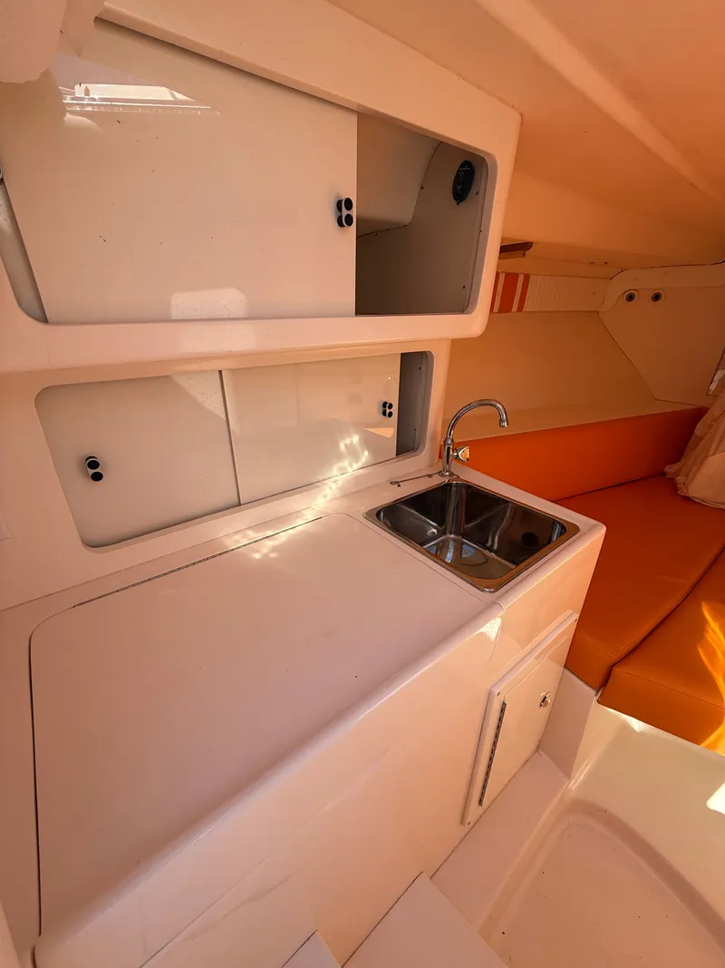 Slide: The Image of Galley area of a 2000 Intrepid 356 yacht with sink and storage. - 16