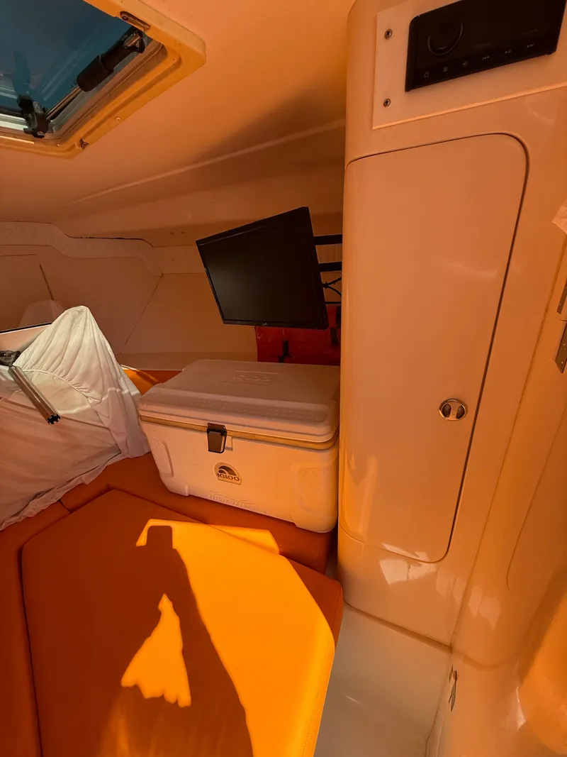 Slide: The Image of Interior of a 2000 Intrepid 356 boat with cooler and monitor. - 18