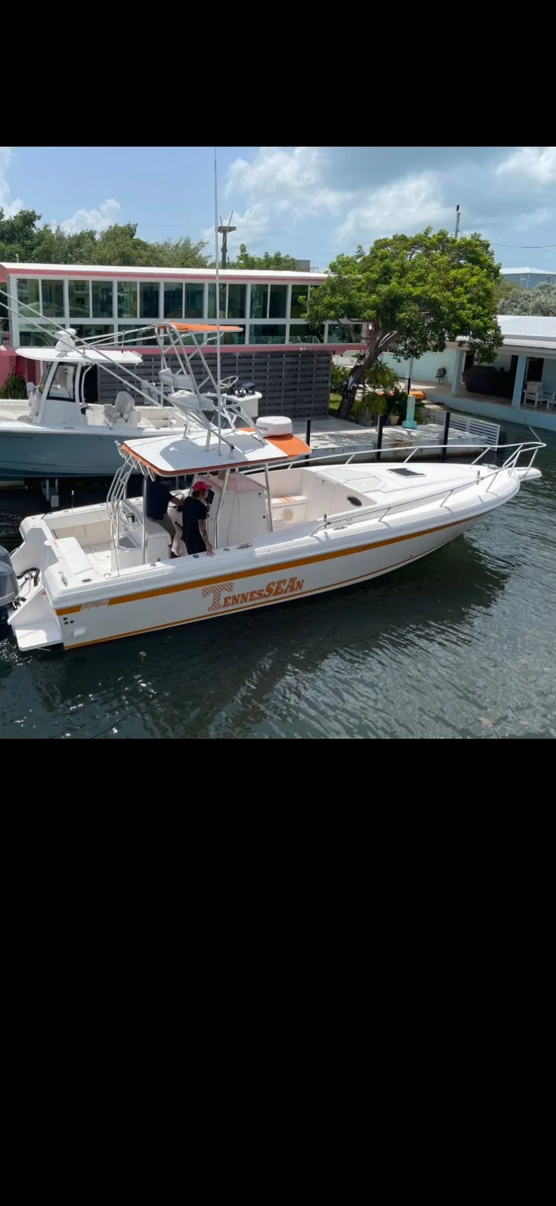 Slide: The Image of Intrepid 356 boat from 2000 on water, sunny day. - 2