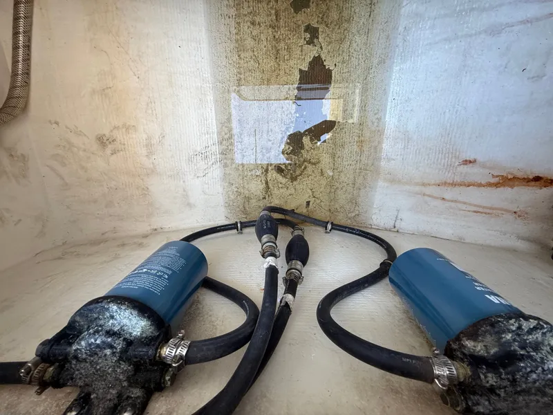 Slide: The Image of Intrepid 356 boat engine compartment with hoses and filters, year 2000. - 30