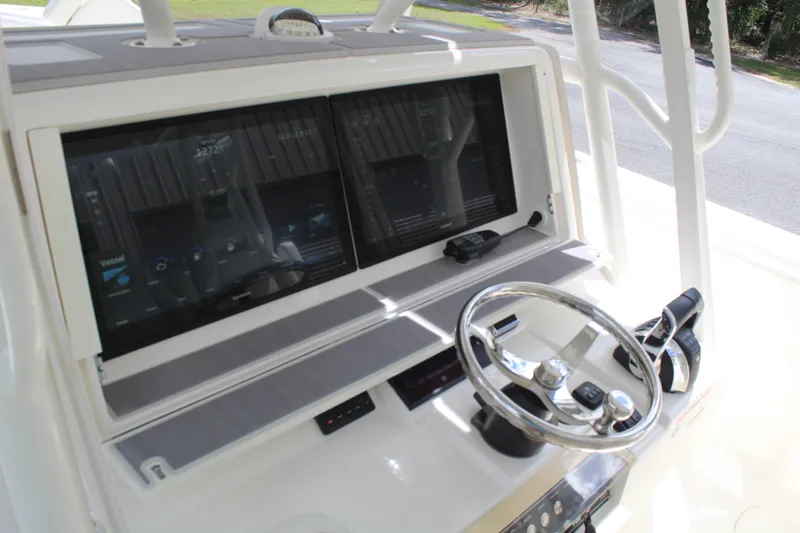Slide: The Image of 2022 SeaVee 370Z boat dashboard with dual screens and steering wheel. - 10