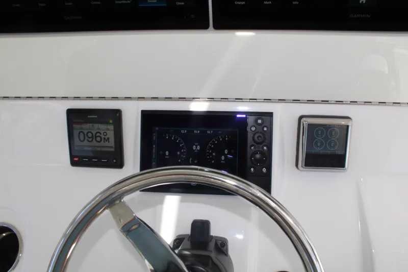 Slide: The Image of 2022 SeaVee 370Z dashboard with Garmin displays and steering wheel. - 12