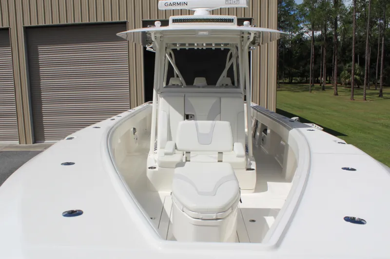 Slide: The Image of 2022 SeaVee 370Z boat with Garmin equipment, docked near a building and trees. - 13