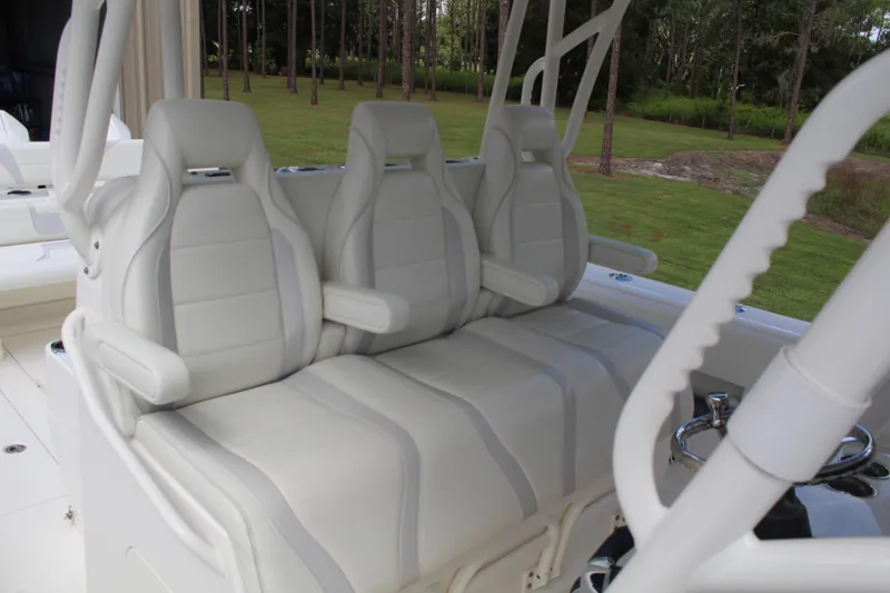 Slide: The Image of 2022 SeaVee 370Z boat with three white cushioned seats, outdoor setting. - 15
