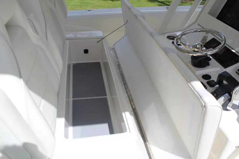 Slide: The Image of 2022 SeaVee 370Z boat interior with white seating and steering console. - 16