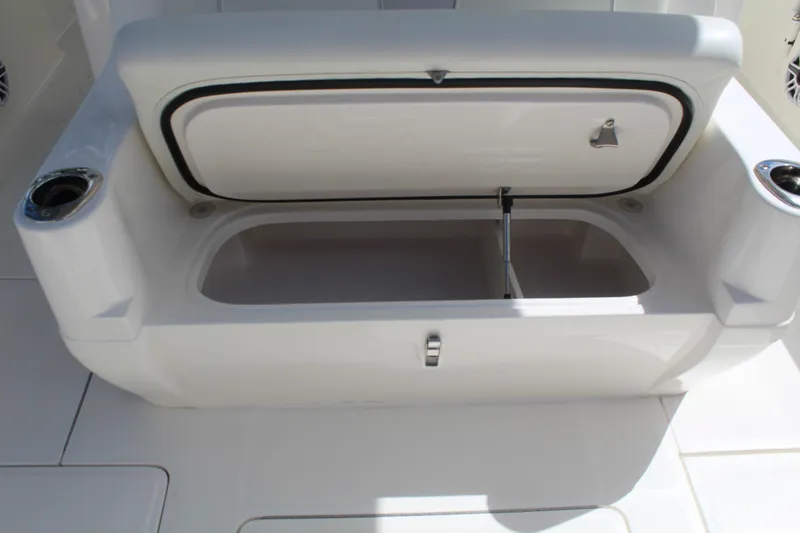 Slide: The Image of 2022 SeaVee 370Z boat storage compartment with open lid and cup holders. - 17