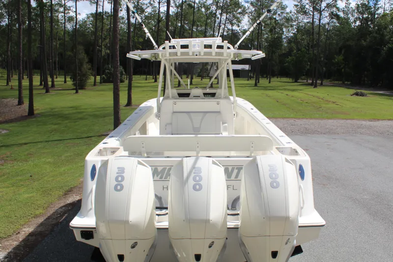 Slide: The Image of 2022 SeaVee 370Z boat with triple 300 horsepower engines, parked in a wooded area. - 18