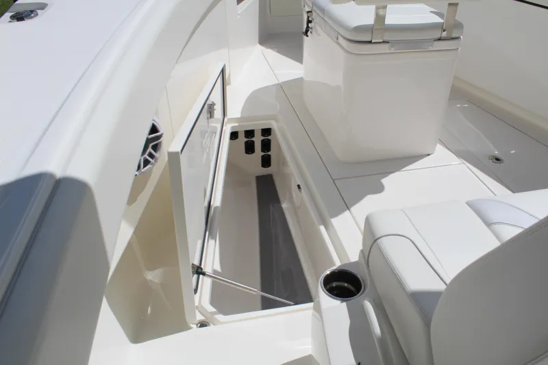 Slide: The Image of 2022 SeaVee 370Z boat interior with open storage compartment and seating. - 21