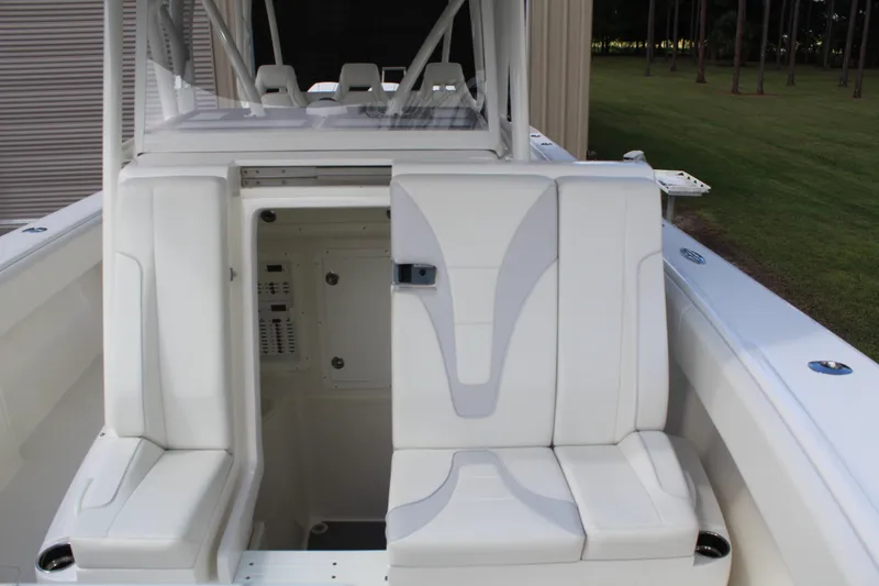 Slide: The Image of 2022 SeaVee 370Z boat interior with white seating and storage compartment. - 25