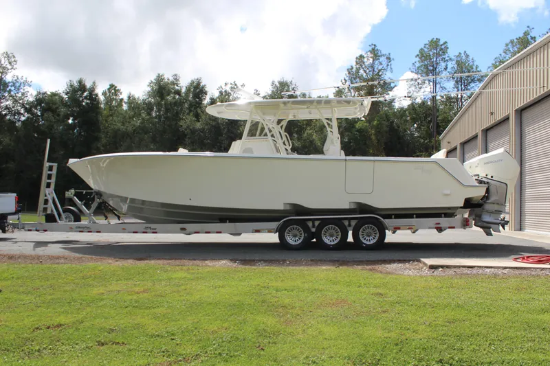 Slide: The Image of 2022 SeaVee 370Z boat on trailer, parked outdoors near a building. - 5
