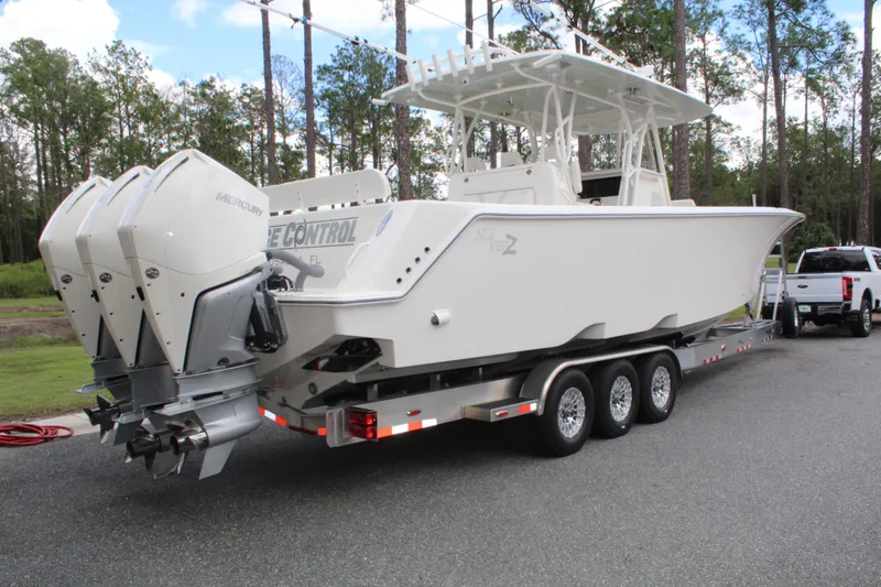 Slide: The Image of 2022 SeaVee 370Z boat on trailer with triple Mercury outboard engines. - 6