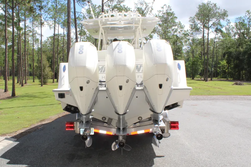 Slide: The Image of 2022 SeaVee 370Z boat with triple outboard engines, parked on a sunny day. - 7