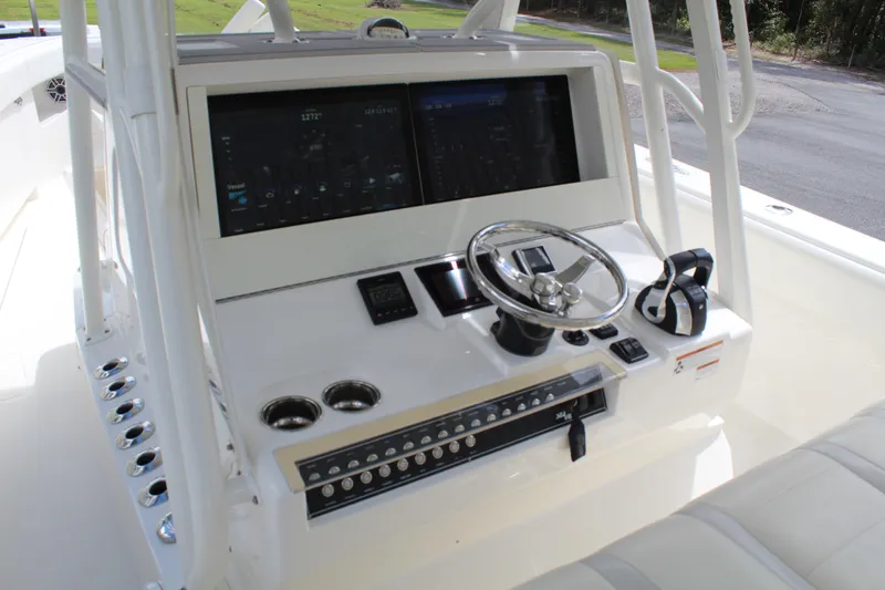 Slide: The Image of 2022 SeaVee 370Z boat console with dual screens and steering wheel. - 8