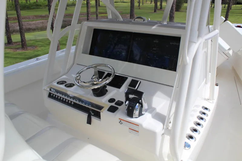 Slide: The Image of 2022 SeaVee 370Z boat helm with dual screens and modern controls. - 9