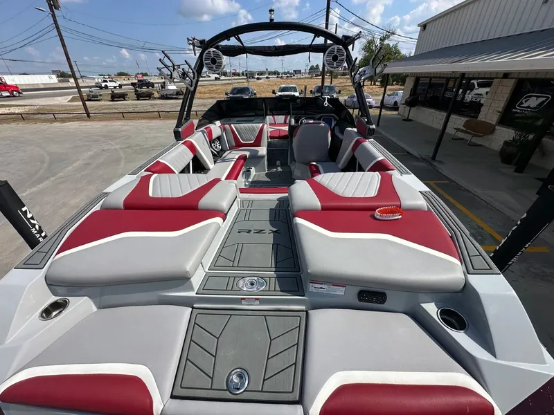 The Image of Interior of a 2021 Tigé 23RZX boat with red and gray seating. - 9