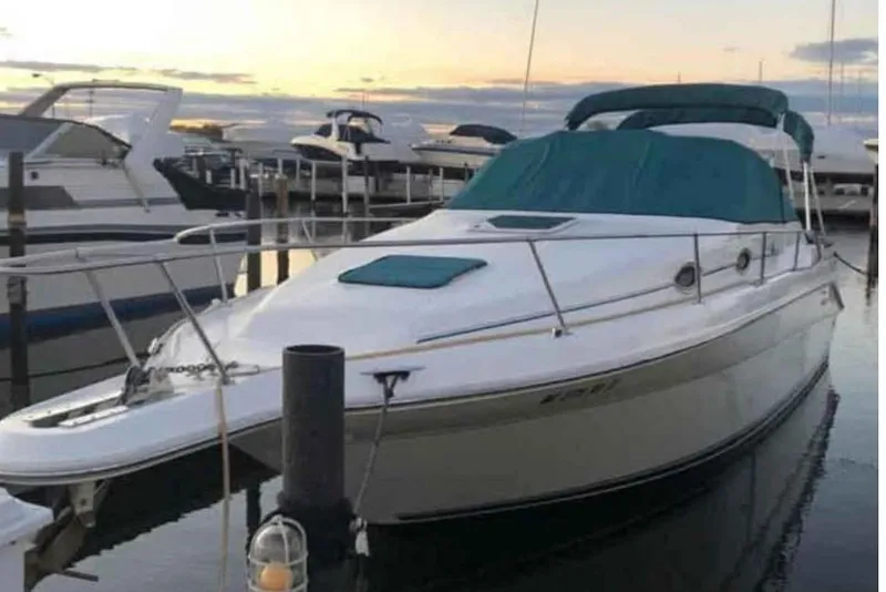 The Image of 1996 Sea Ray 270 Sundancer docked at marina during sunset. - 1