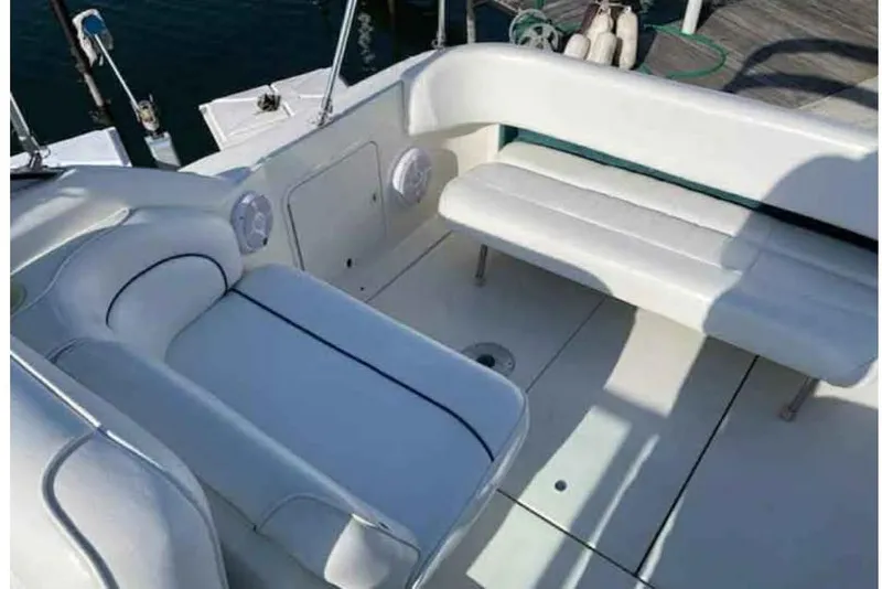 Slide: The Image of 1996 Sea Ray 270 Sundancer boat interior with white seating and deck. - 4