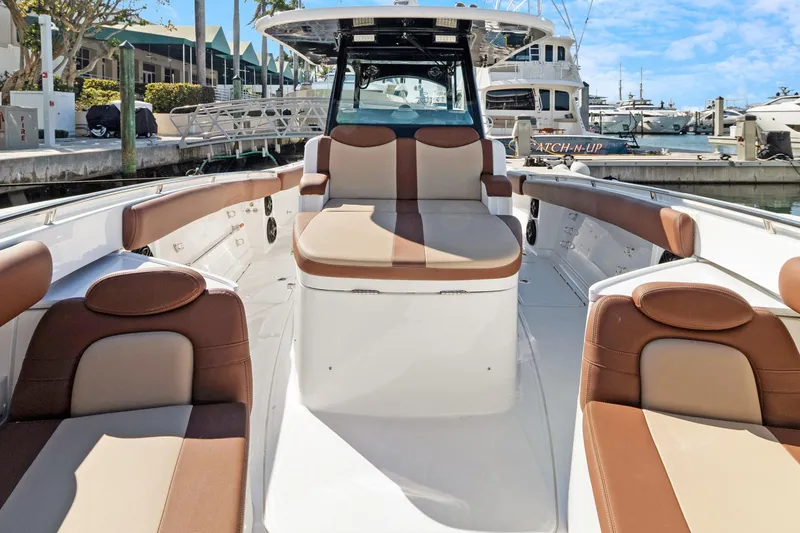 Slide: The Image of 2023 HCB Speciale boat interior with brown and beige seating at marina. - 10