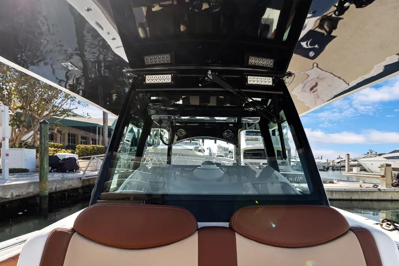 Slide: The Image of 2023 HCB Speciale boat interior with sleek design and modern features at a marina. - 11