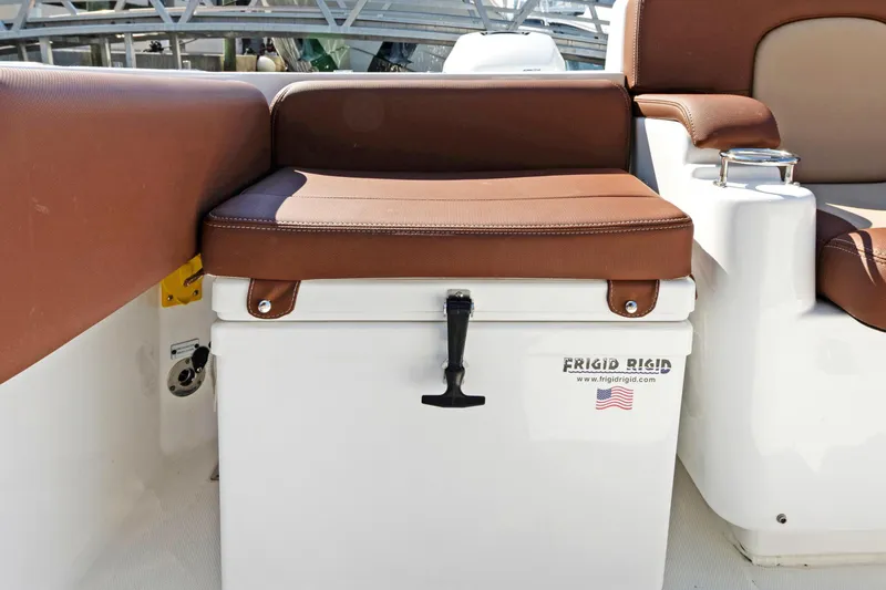 Slide: The Image of 2023 HCB Speciale boat interior with cushioned seating and Frigid Rigid cooler. - 17