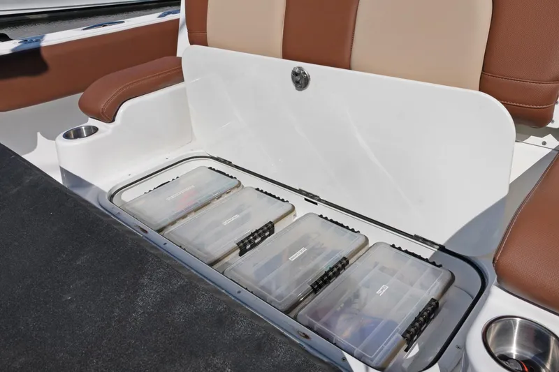 Slide: The Image of 2023 HCB Speciale boat storage compartment with organized tackle boxes. - 18
