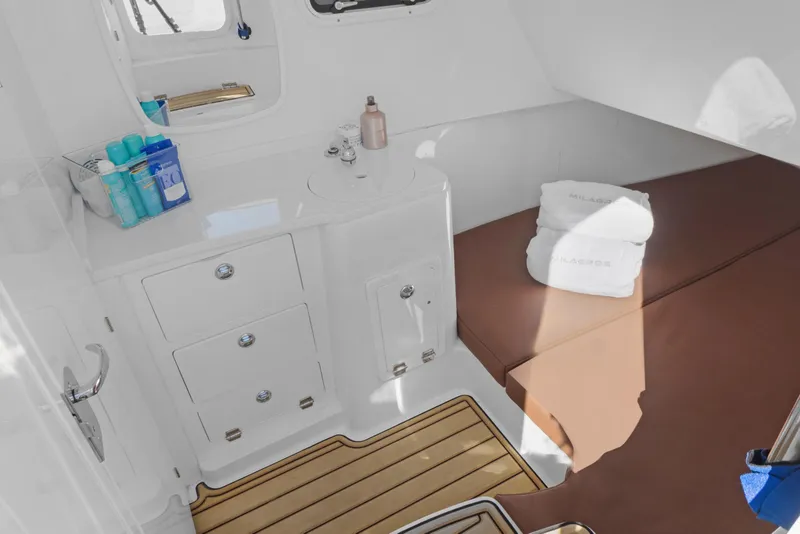 Slide: The Image of 2023 HCB Speciale cabin interior with sink, storage, and brown seating area. - 23