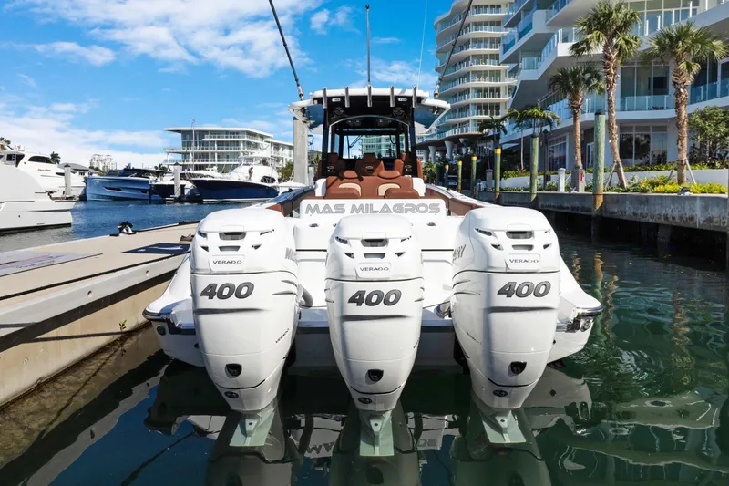 Slide: The Image of 2023 HCB Speciale boat with triple Mercury Verado 400 engines docked in a marina. - 24