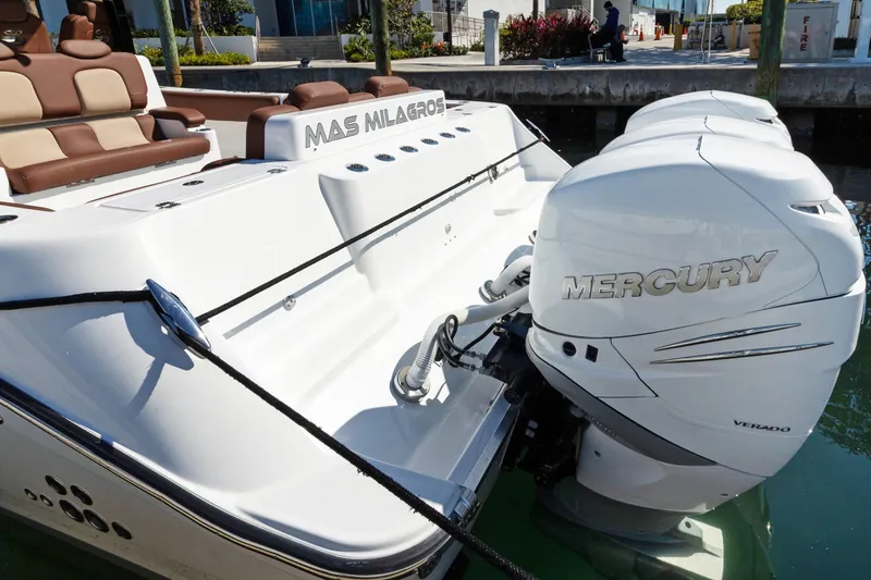 Slide: The Image of 2023 HCB Speciale boat with Mercury Verado engines docked at marina. - 4