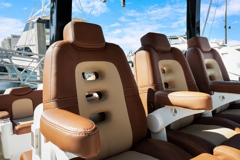 Slide: The Image of Luxurious brown leather seats on 2023 HCB Speciale boat, docked at marina. - 6
