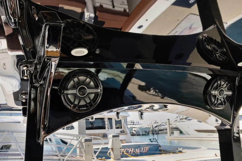 Slide: The Image of 2023 HCB Speciale boat with sleek black finish and integrated JL Audio speakers. - 8