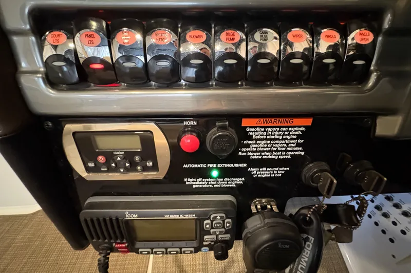 Slide: The Image of Control panel of a 2016 Formula 310 Bowrider boat with switches and warning labels. - 12