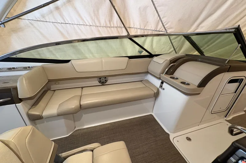 Slide: The Image of 2016 Formula 310 Bowrider interior with beige seating and cup holders. - 18