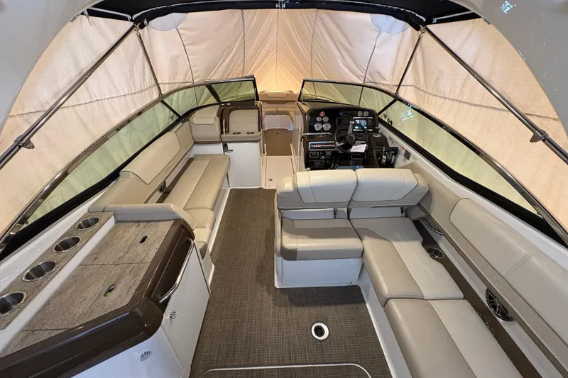 Slide: The Image of 2016 Formula 310 Bowrider interior with seating, helm, and canopy. - 22