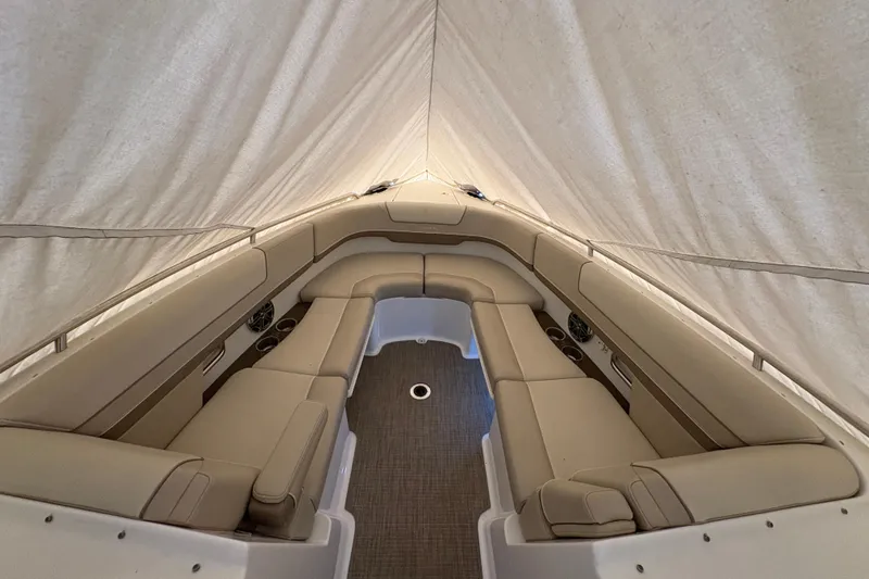 Slide: The Image of 2016 Formula 310 Bowrider interior with beige seating under a canopy. - 23