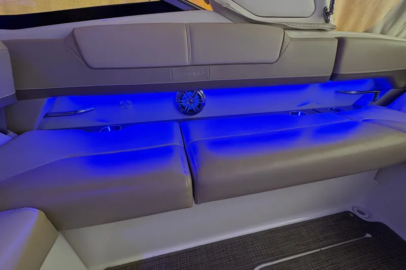 Slide: The Image of 2016 Formula 310 Bowrider interior with blue LED lighting and cushioned seating. - 24