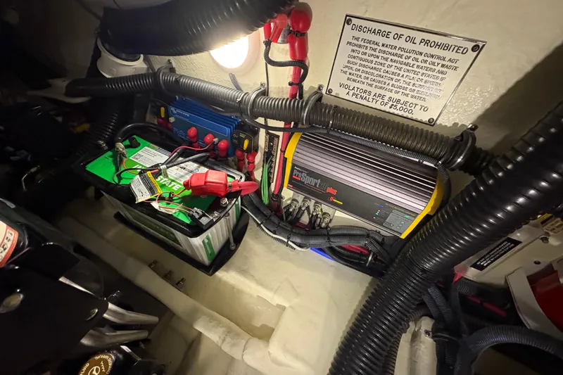 Slide: The Image of Engine compartment of a 2016 Formula 310 Bowrider with battery and wiring components. - 32