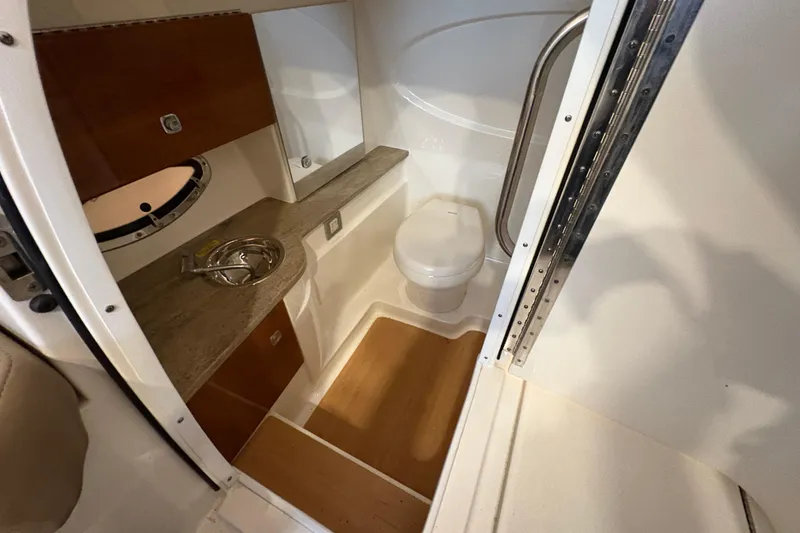 Slide: The Image of 2016 Formula 310 Bowrider bathroom with sink, toilet, and wooden accents. - 36