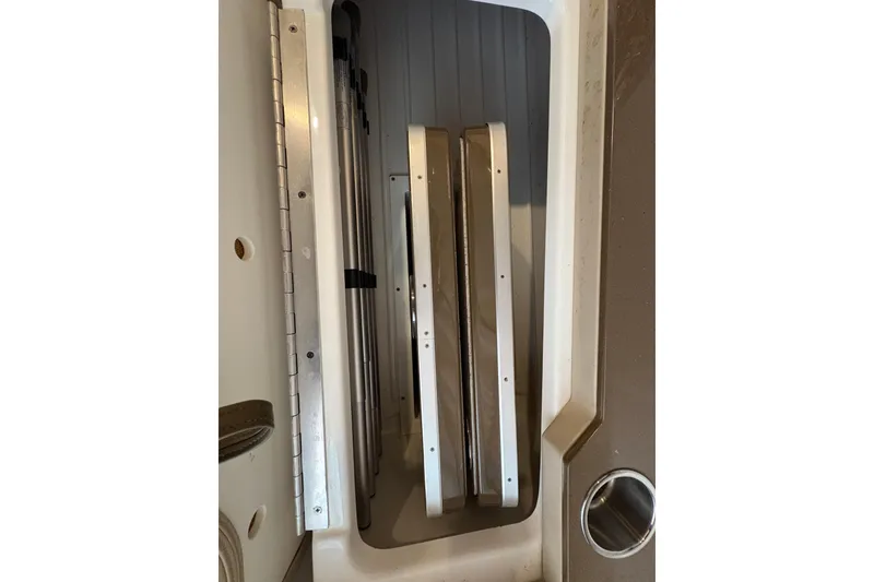 Slide: The Image of Storage compartment of a 2016 Formula 310 Bowrider boat, featuring metal components. - 41