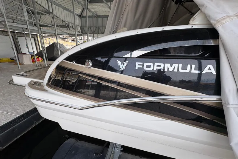 Slide: The Image of 2016 Formula 310 Bowrider boat docked under a covered marina. - 45